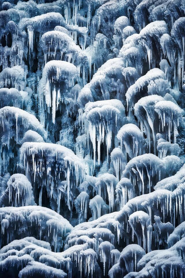 Blue ice forms on Rainbows Falls during a cold winter day.