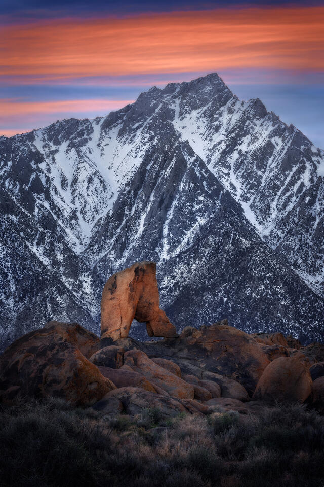 Lone Pine Peak towers over Boot Arch during a winter sunset in California's Alabama Hills.