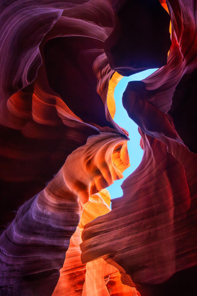 A sliver of blue sky lets light into Antelope Canyon above a rock formation that resembles the head of an eagle.