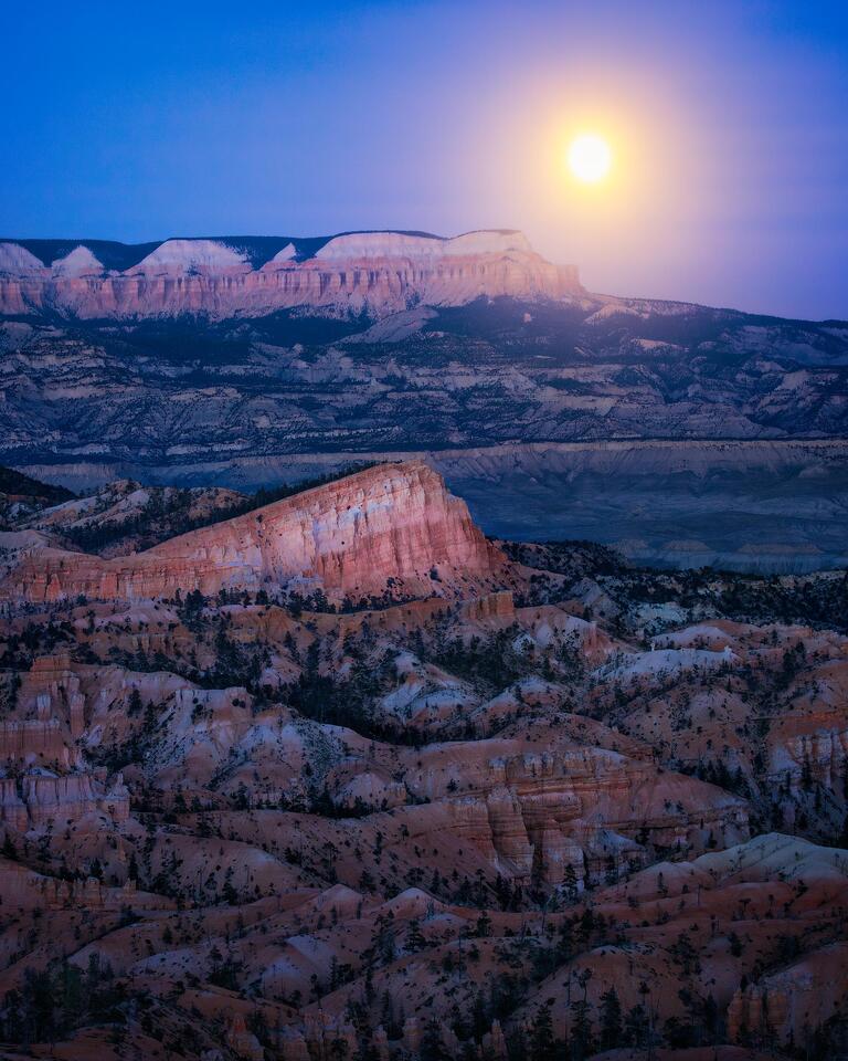 A winter moonrise in Utah’s Bryce Canyon National Park above a prominent rock formation in the midground known as the Sinking Ship.