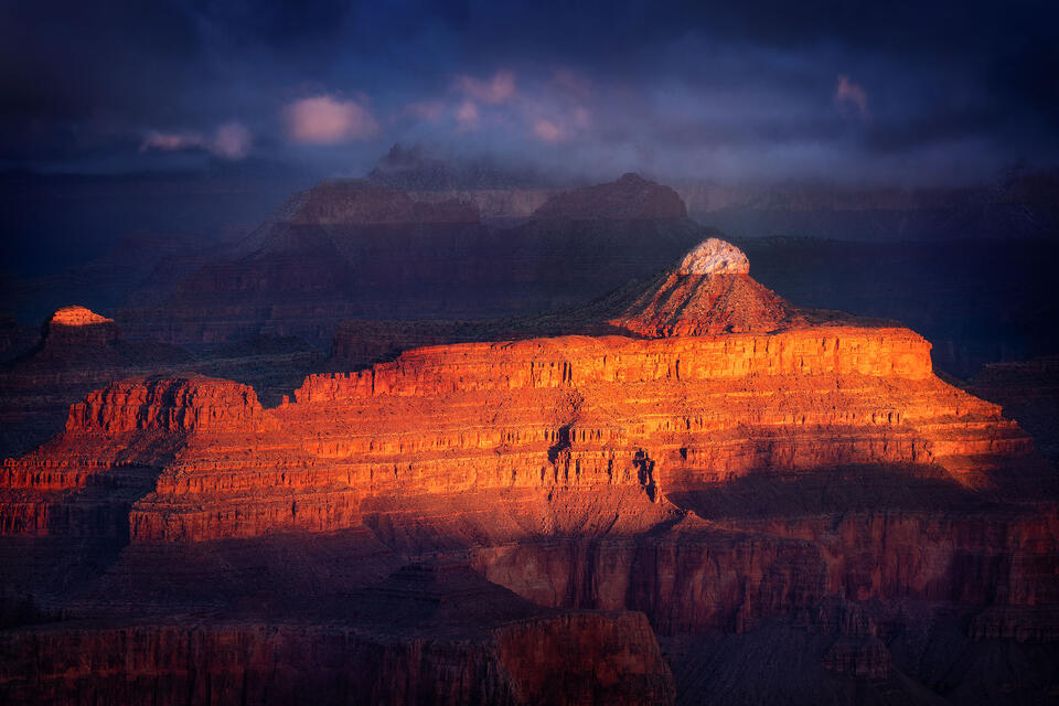 A sliver of light at sunrise illuminates the Grand Canyon the morning after a dramatic winter storm.