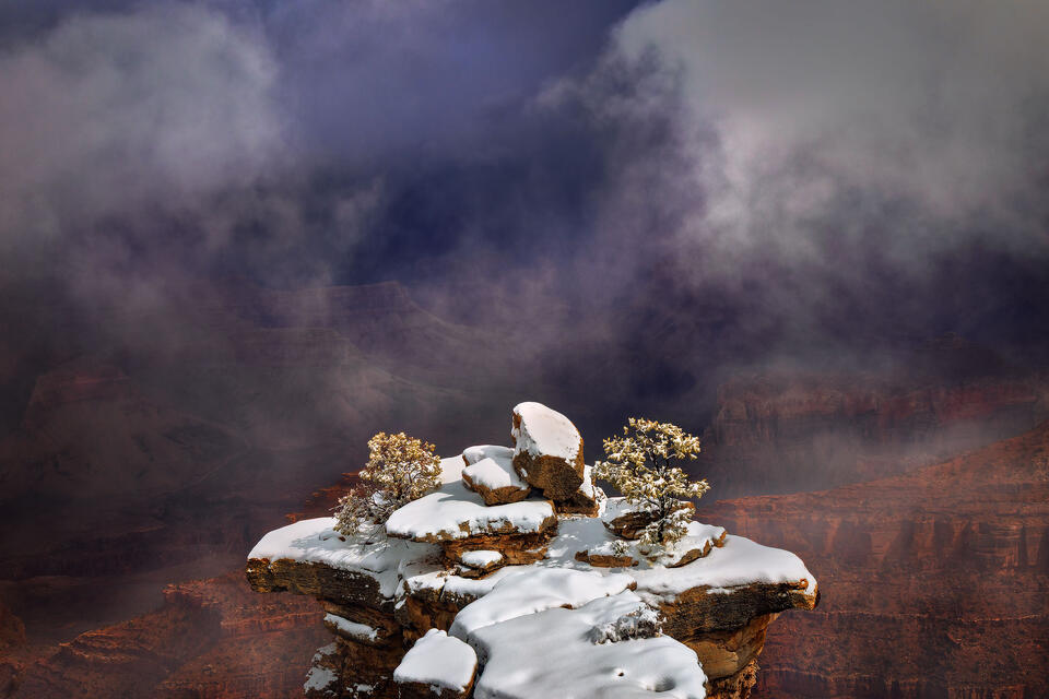 A snow-covered peninsula seems to levitate over the Grand Canyon as a winter storm clears.