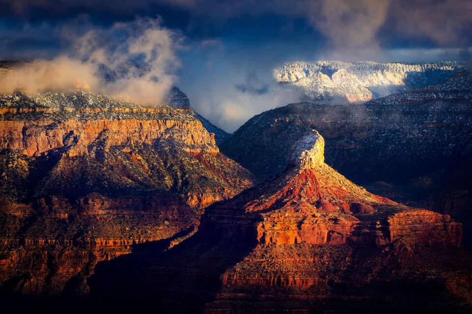 Storm clouds swirl above Isis Temple and the snowy North Rim of the Grand Canyon after a February snowstorm.