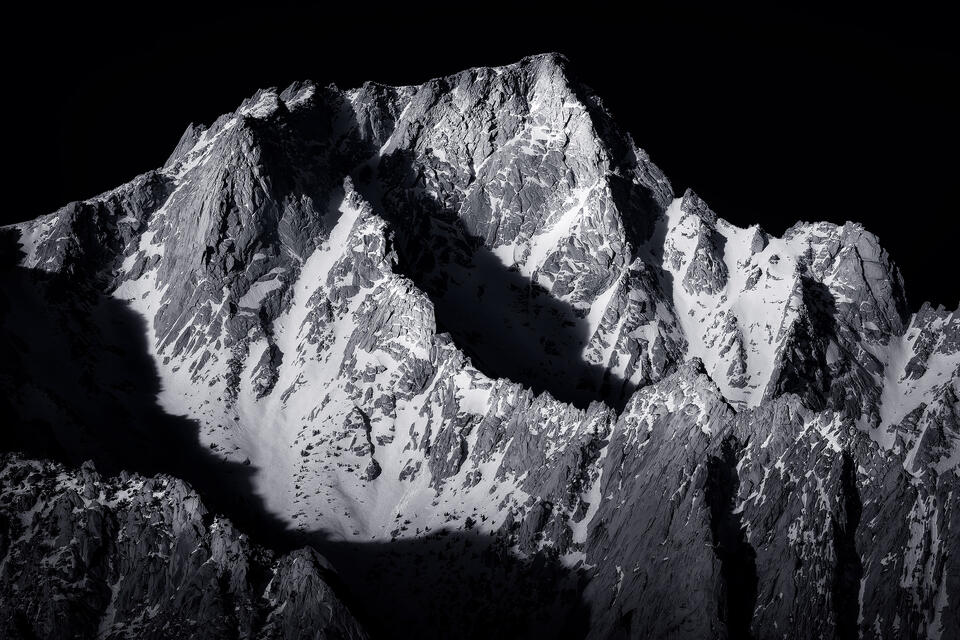 Morning light accentuates the jagged ridges of Lone Pine Peak in the Alabama Hills of California in winter.
