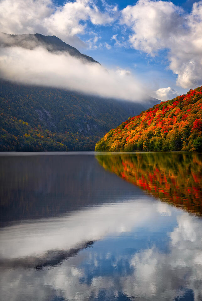 Sun and foliage break through morning fog at Lower Ausable Lake. 
