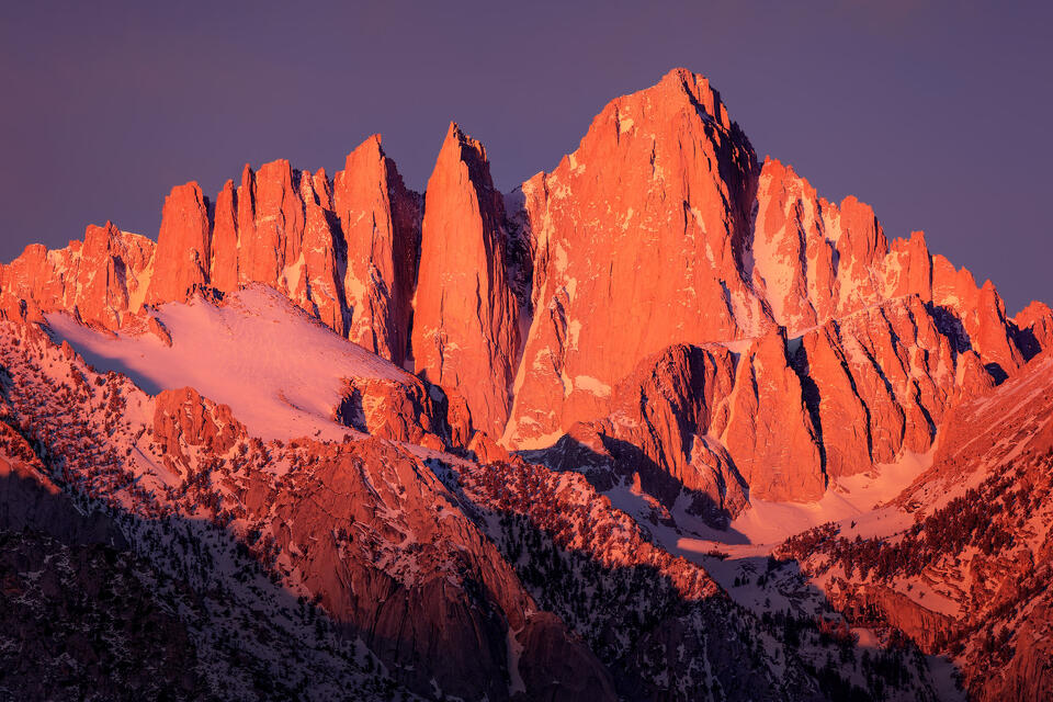 A winter sunrise illuminates Mount Whitney in the Alabama Hills of California.