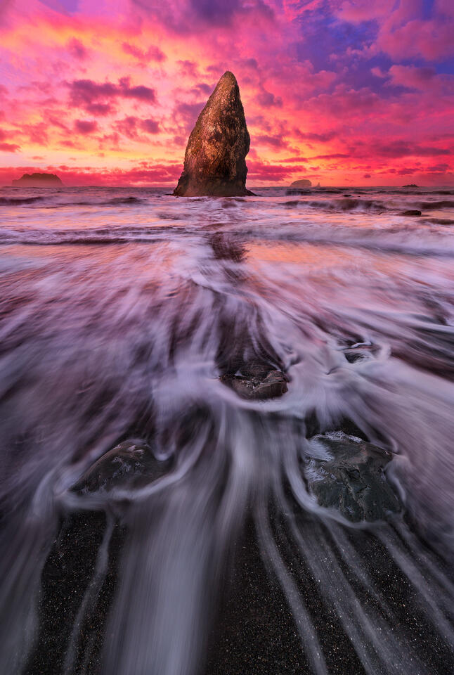 A sea stack stands out against a beautiful sunset in Olympic National Park.