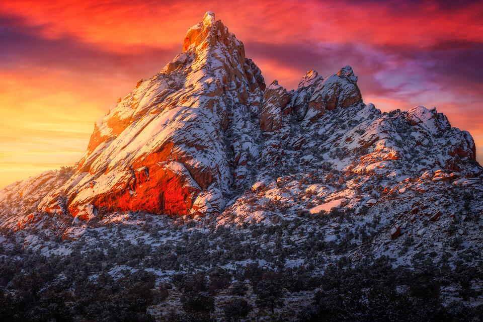 A snow-covered sandstone mountain near Page, Arizona the catches sunlight on a frigid morning.