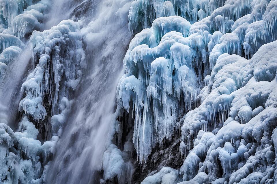 Blue ice hangs from the cliff of Rainbow Falls.