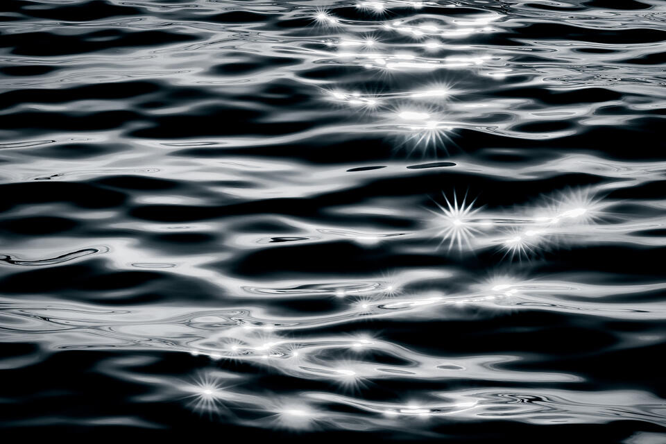 An abstract black and white rendition of sunshine reflecting in the surface of New York’s Lake Ontario.