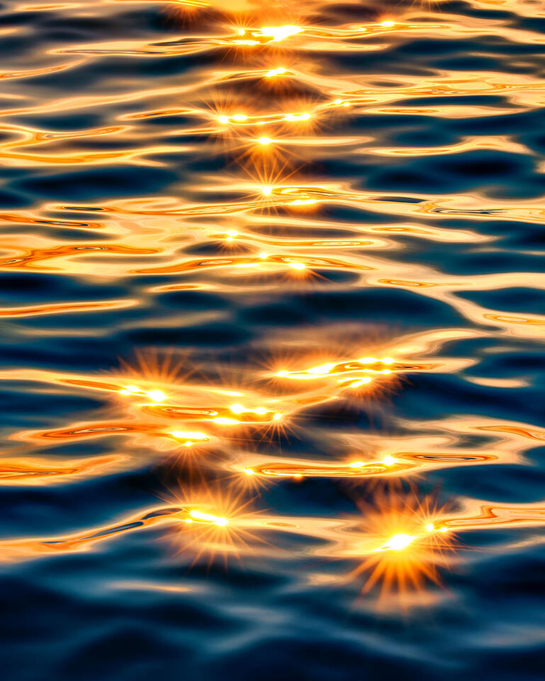 The setting sun seems to melt into the surface of New York’s Lake Ontario.
