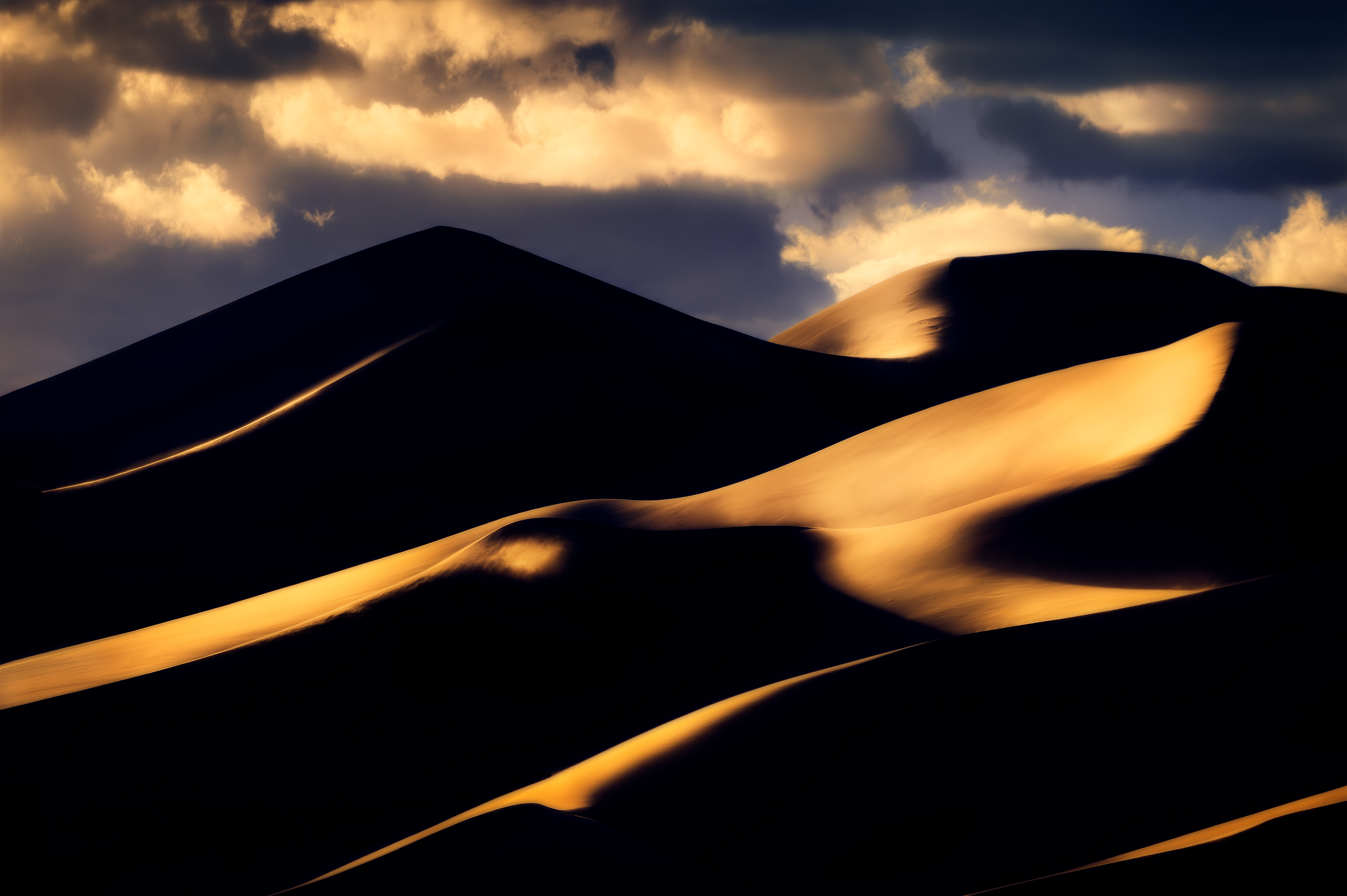 Dramatic Dunes Dramatic layers of light and shadow at sunset in Colorado's Great Sand Dunes National Park, which is home to the tallest sand dunes in North America.