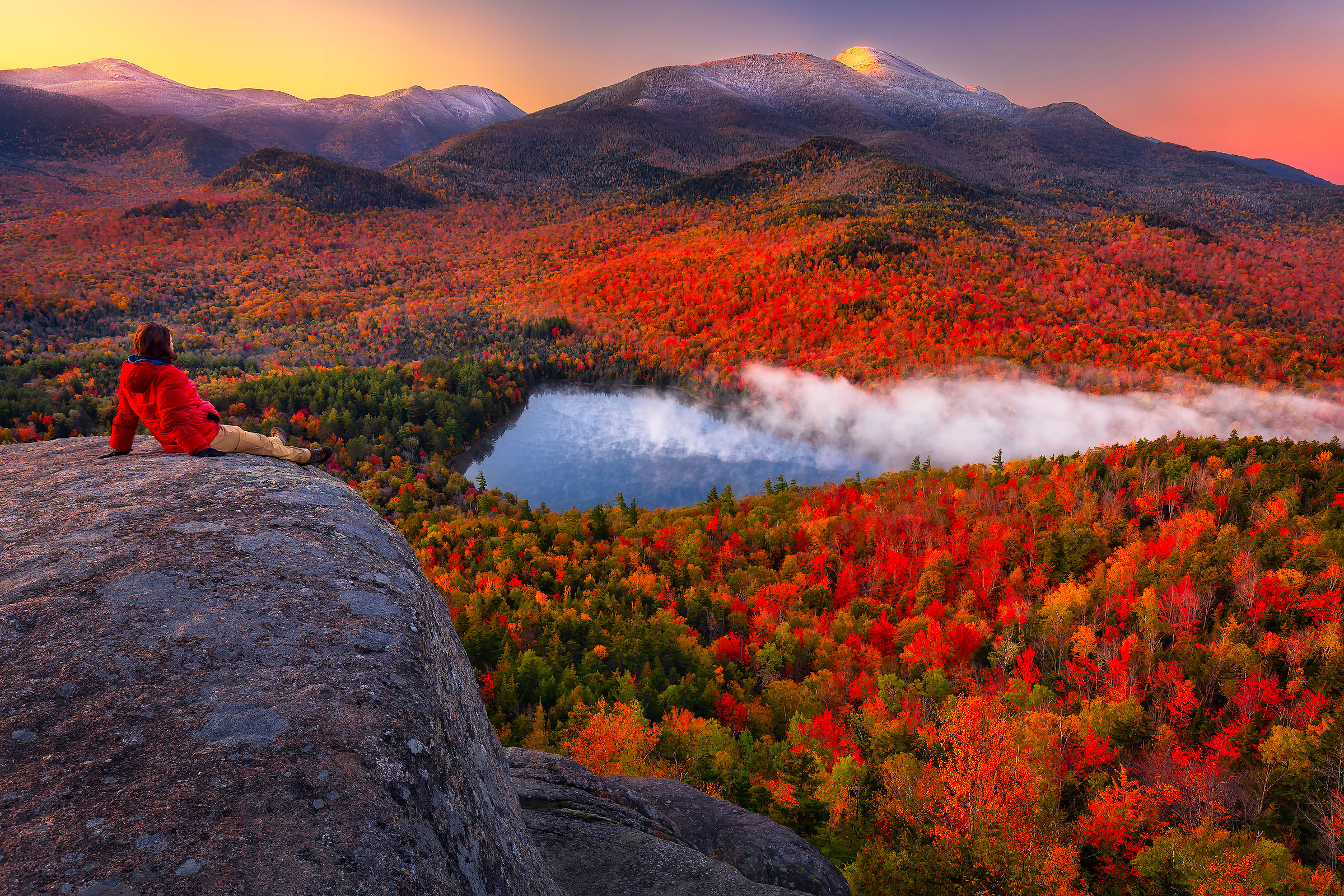 Soak It In Taking in the view of autumn colors spread out below the snow-capped summit of Algonquin Peak, as morning fog drifts off the surface of a lake on a cold October morning at sunrise. As hard as it can be to extract myself from the warm cocoon of my sleeping bag on cold mornings such as this one, viewing and photographing the sunrise always makes it more than worth it.